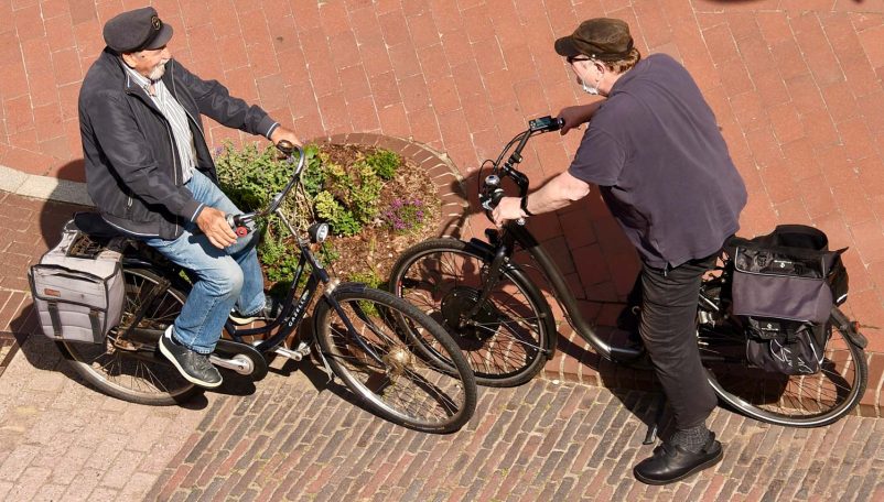 Zwei Personen auf Fahrrädern unterhalten sich